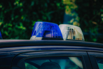 Close-up of car against blue sky