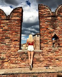 Rear view of woman standing on fort