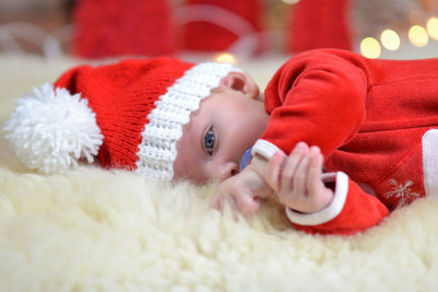 Portrait of a newborn baby in christmas clothes and santa hat