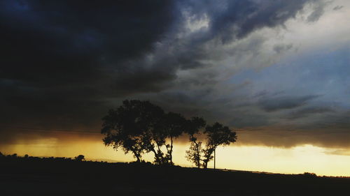 Silhouette of landscape against cloudy sky