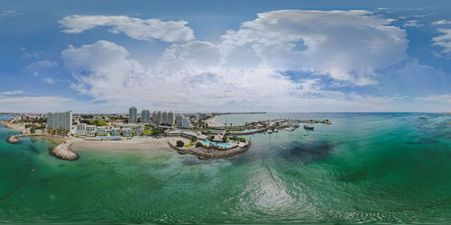 View of swimming pool in sea against cloudy sky