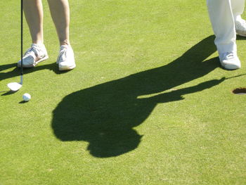 Low section of people standing on golf course