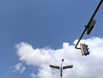 Low angle view of sign against blue sky