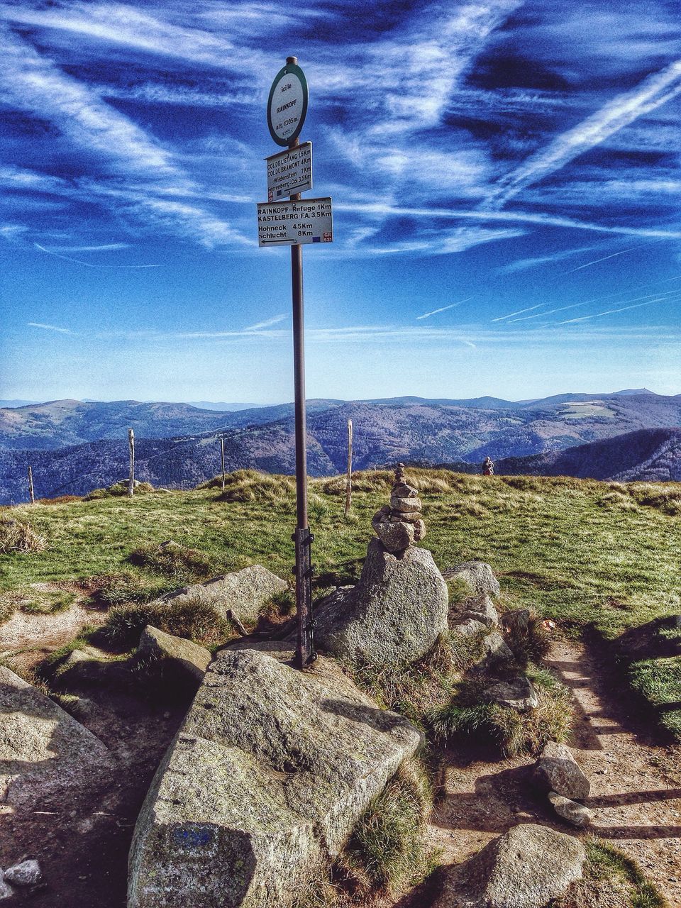 communication, text, sky, guidance, western script, information sign, sign, landscape, road sign, tranquility, field, nature, blue, tranquil scene, day, plant, arrow symbol, direction, grass, directional sign