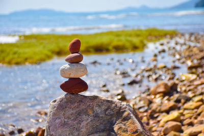 Close-up of pebbles on beach against sky