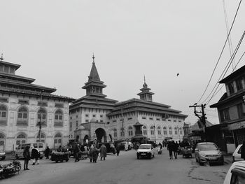 People in town square against clear sky