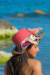 Rear view of woman wearing hat at beach