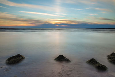 Scenic view of sea against sky at sunset