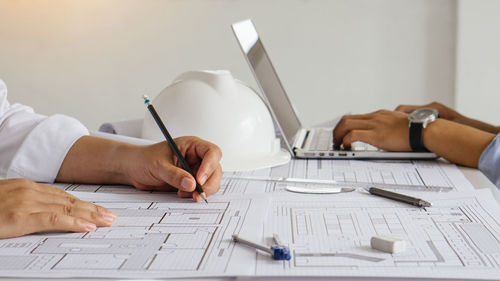 Midsection of man working on table