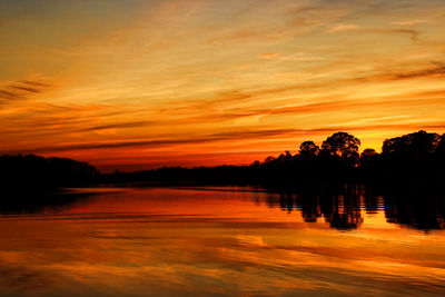 Scenic view of lake against romantic sky at sunset