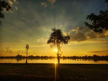 Scenic view of field against sky during sunset