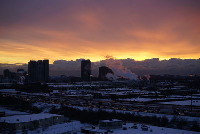 View of cityscape during winter at sunset