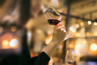 Person holding glass of wine