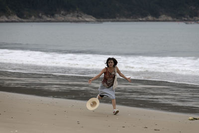 Full length of woman standing on beach