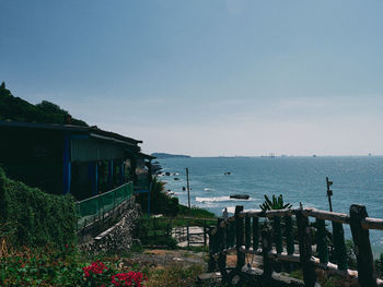 Building by sea against sky