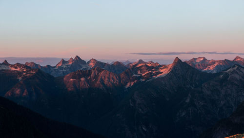 Scenic view of mountains against clear sky during sunset
