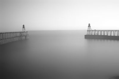 Pier on sea against clear sky