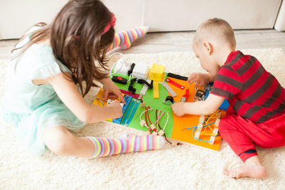 Cute girl playing with toy toys at home