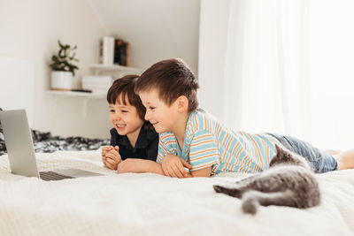 Children and technology. a schoolboy and a little boy are looking at something in a laptop 