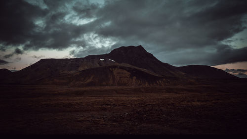 Scenic view of mountains against cloudy sky