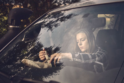 Reflection of woman in car mirror