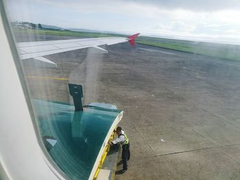 Man on airplane against sky