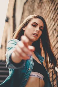 Close-up portrait of young woman standing outdoors