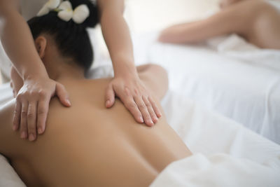 Young woman being massaged on table in spa