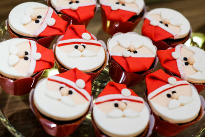 Close-up of santa clause cupcakes on table