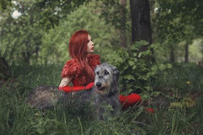Young woman with dog on grass