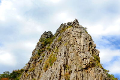 Low angle view of rock formation against sky