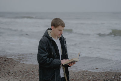 A young man fascinated by a book, reads fiction, immersed in the study of the material