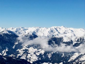 Scenic view of snowcapped mountains against clear blue sky