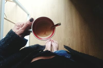 Person holding coffee cup