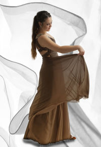 Young woman standing against white wall