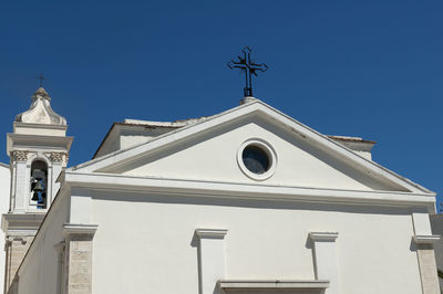 Low angle view of building against clear blue sky