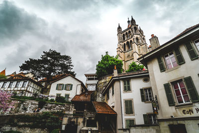 Low angle view of building against cloudy sky