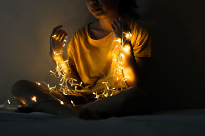 Midsection of woman with lighting