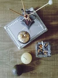 High angle view of decorations with ashtray on wooden table