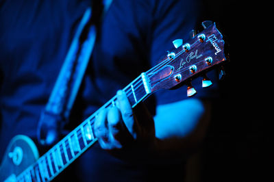 Close-up of man playing guitar