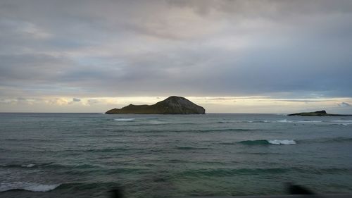 Scenic view of sea against cloudy sky