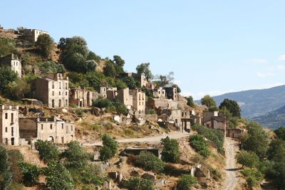 Old town by buildings against clear sky