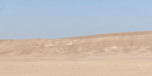 Scenic view of desert against clear sky