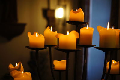 Close-up of lit candles burning in building