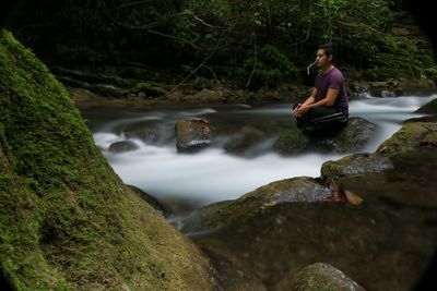 Man standing by river stream at night