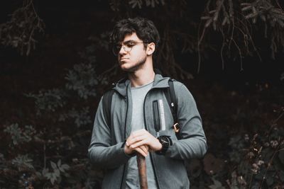 Young man looking away in forest