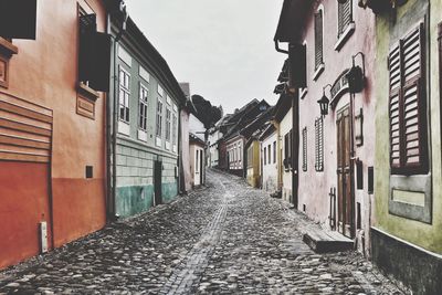 Alley amidst buildings against sky