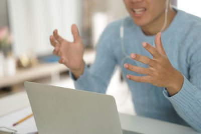 Midsection of woman using mobile phone