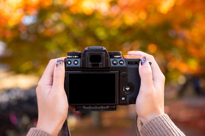 Close-up of hand holding camera