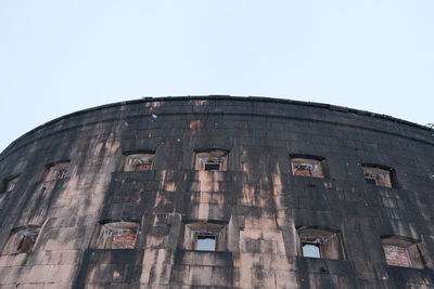 Low angle view of old building against clear sky